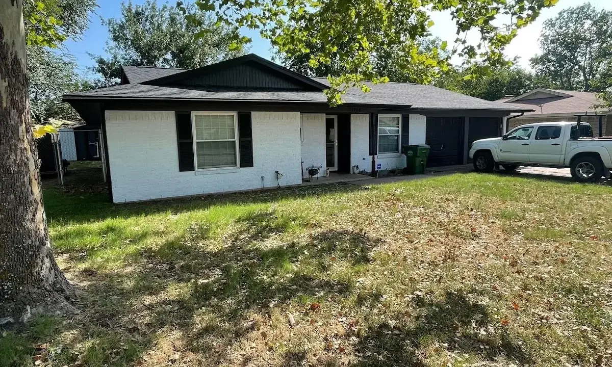 Professional roofing crew working on a residential roof in Three Oaks